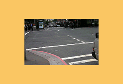 You wish to turn left here. The pedestrian lights are flashing red. You should -