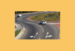 When you wish to drive straight ahead at a roundabout, you may enter from either the left or right lane. As you continue around you should -