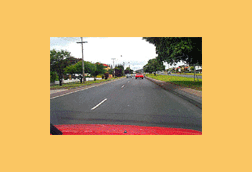 The speed limit on this road is 90 km/h. You have just overtaken a vehicle that is travelling in the left lane. What should you do next?