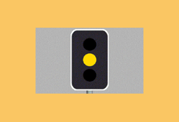What should you do when approaching traffic lights which change from green to amber?
