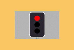 As you approach an intersection with traffic lights, the amber light turns to red. You must: