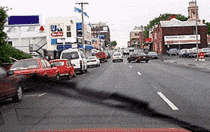 You are driving along this road. You hear an ambulance's siren and see the ambulance in your mirror. You should -