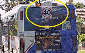 When you see these lights flashing on the back of a bus, what should you do?