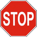 你开到一个有停车(STOP)标志的交叉路口。路上没有停车线。你应在哪里停下？