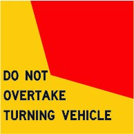 You are behind a truck that is signalling and starting to turn left. The truck is displaying a 'Do not overtake turning vehicle' sign and is in the second lane from the left side of the road. You also want to turn left. What must you do?