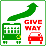 You are driving in a built-up area (like a city or town).  A bus is stopped at a bus stop in the left lane next to you and has this sign displayed.  There are parked vehicles in front of the bus and it has signalled right. What must you do?