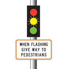 You approach this set of traffic lights. The yellow light is flashing and there are no pedestrians waiting to cross. What should you do?